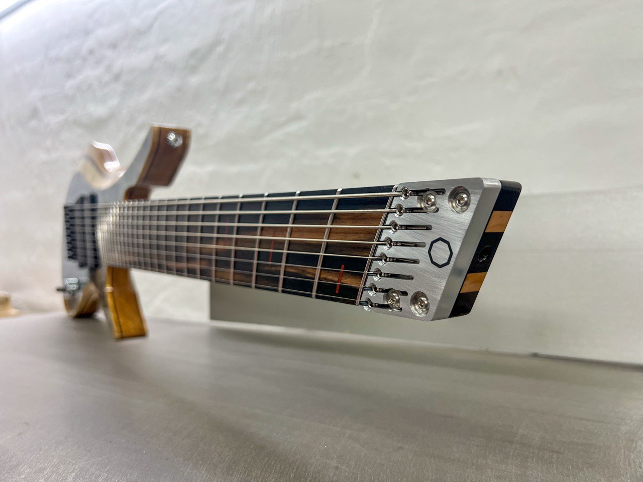 Constance 8 string headless guitar headpiece focus